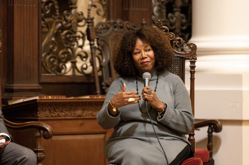 Ruby bridges sitting in the front of memorial church with a microphone in her hand.