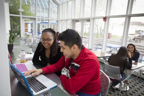 Two students looking at a computer screen