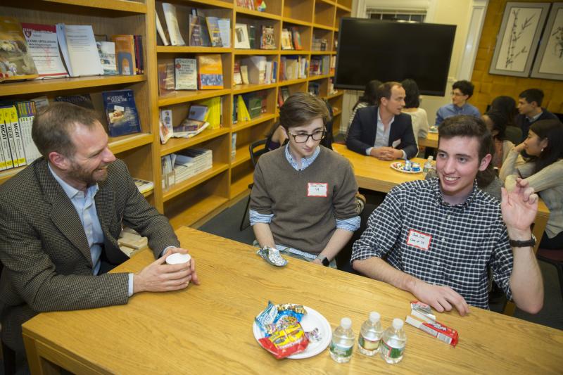 Music professor, Alex Rehding, (from left) talks with Jake Tilton '19 and Jacob Link '19 inside the Office for Career Services during a dinner with arts and humanities faculty and students.
